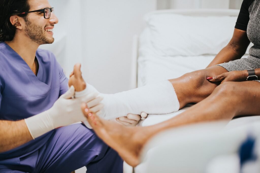 Doctor helping a patient with a fractured leg