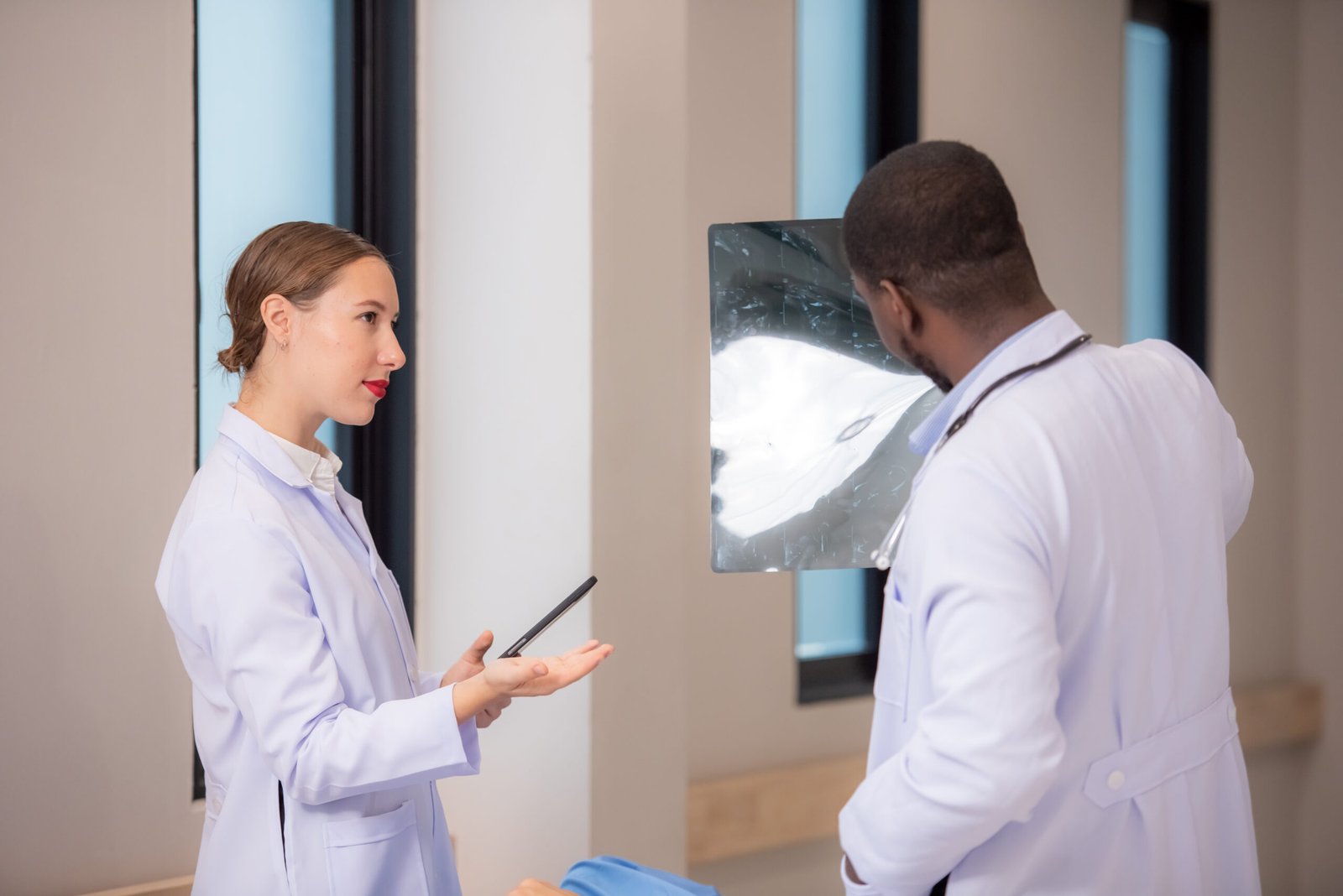 doctor examining x-ray in corridor of hospital