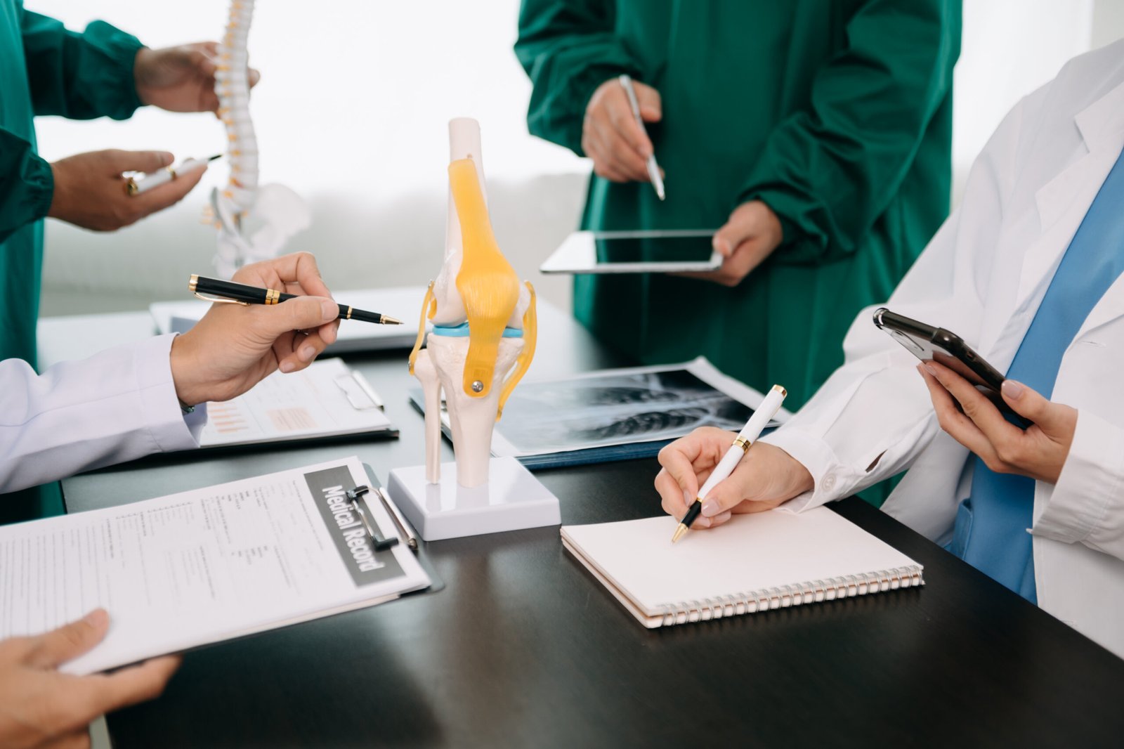 Medical technology network team meeting concept. Doctor hand working with smart phone modern digital tablet and laptop computer with graphics chart interface, with virtual icon diagram