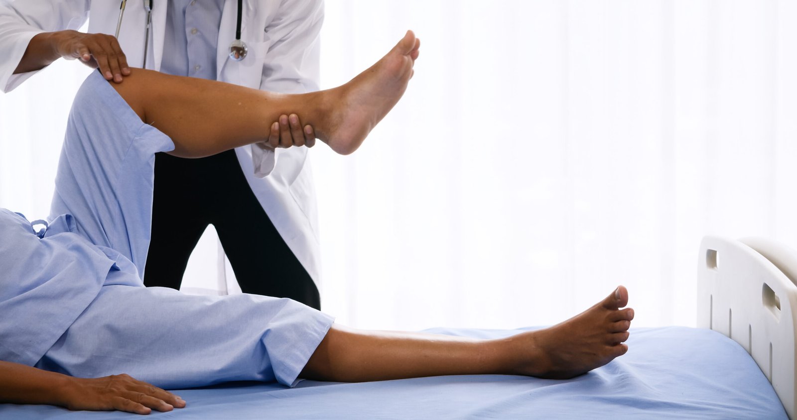 Physical therapist doing physical therapy for adult patient at hospital room.