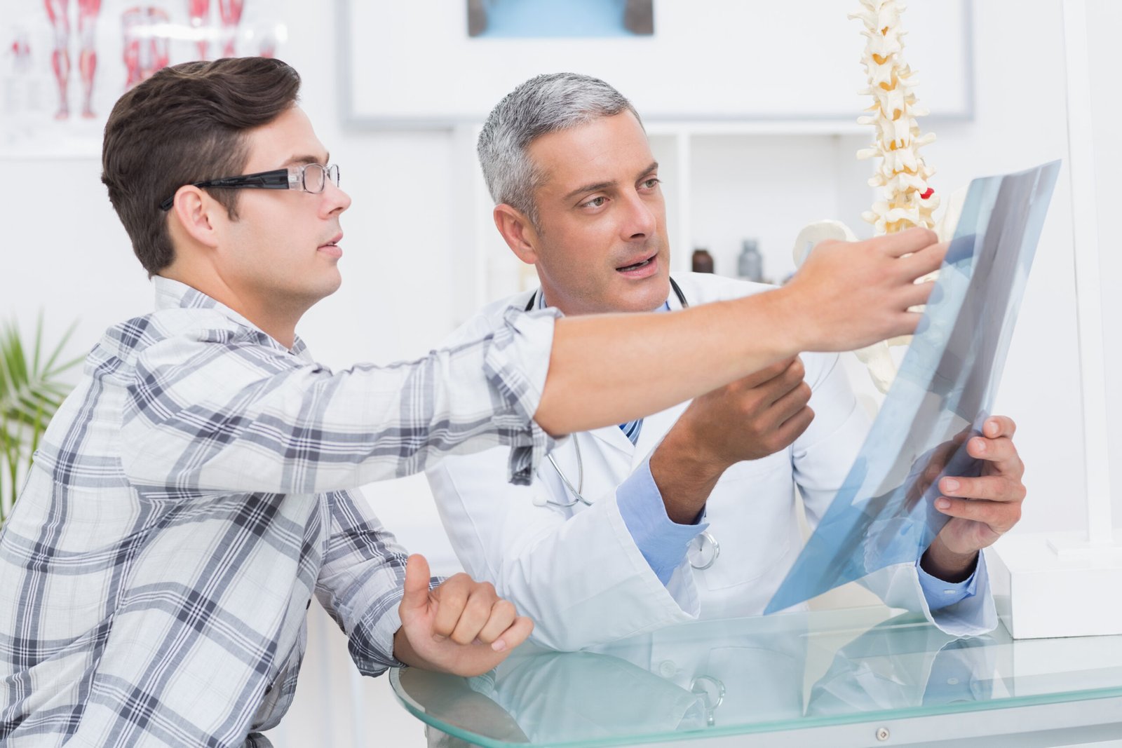 Doctor showing Xrays to his patient in medical office
